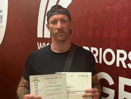 Roy Bannister holding a certificate